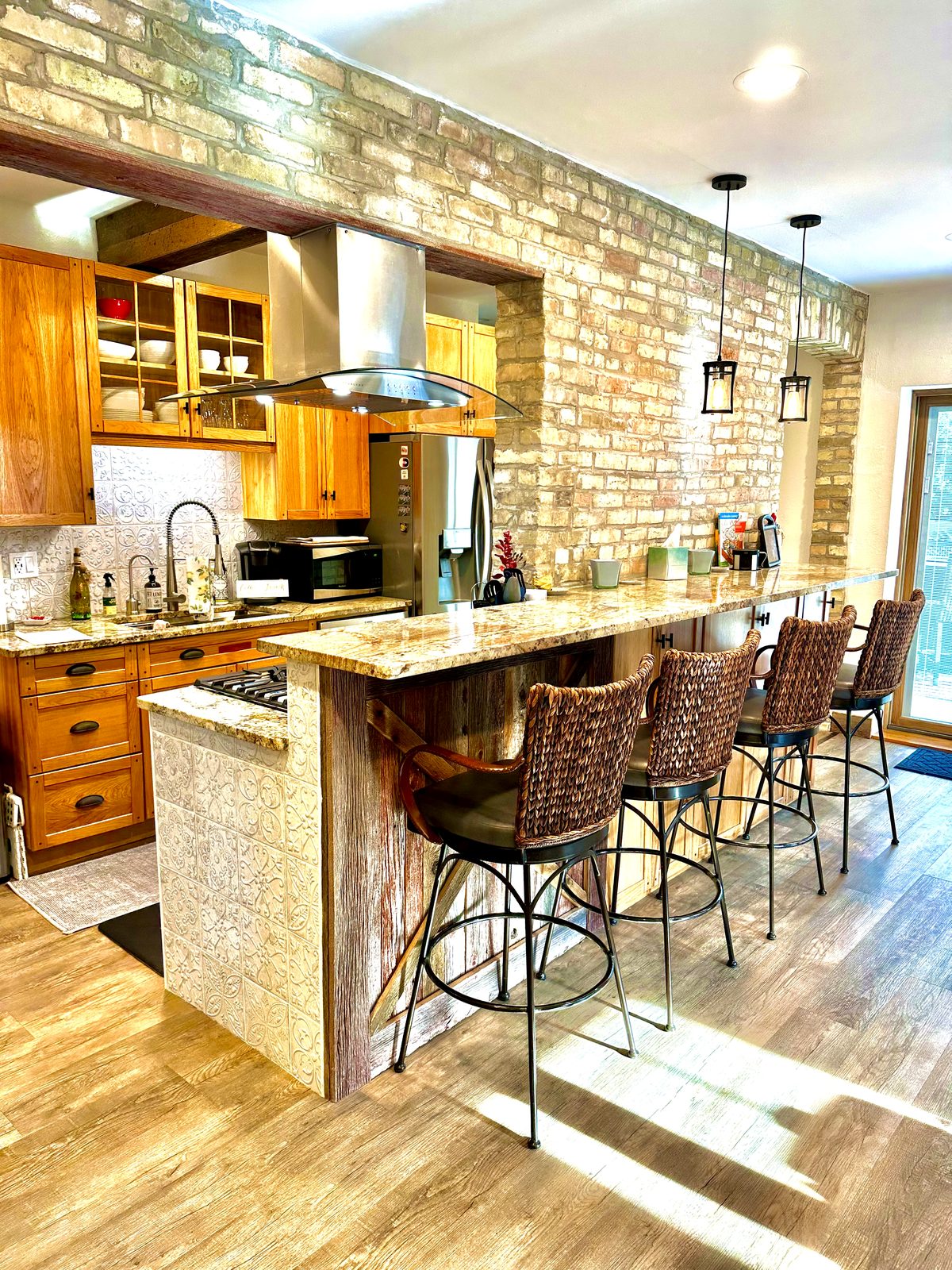 Granite kitchen bar with seating and exposed Cream City Brick